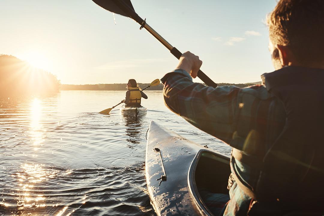 residents kayaking on a lake at Pelican Shores at Water Valley